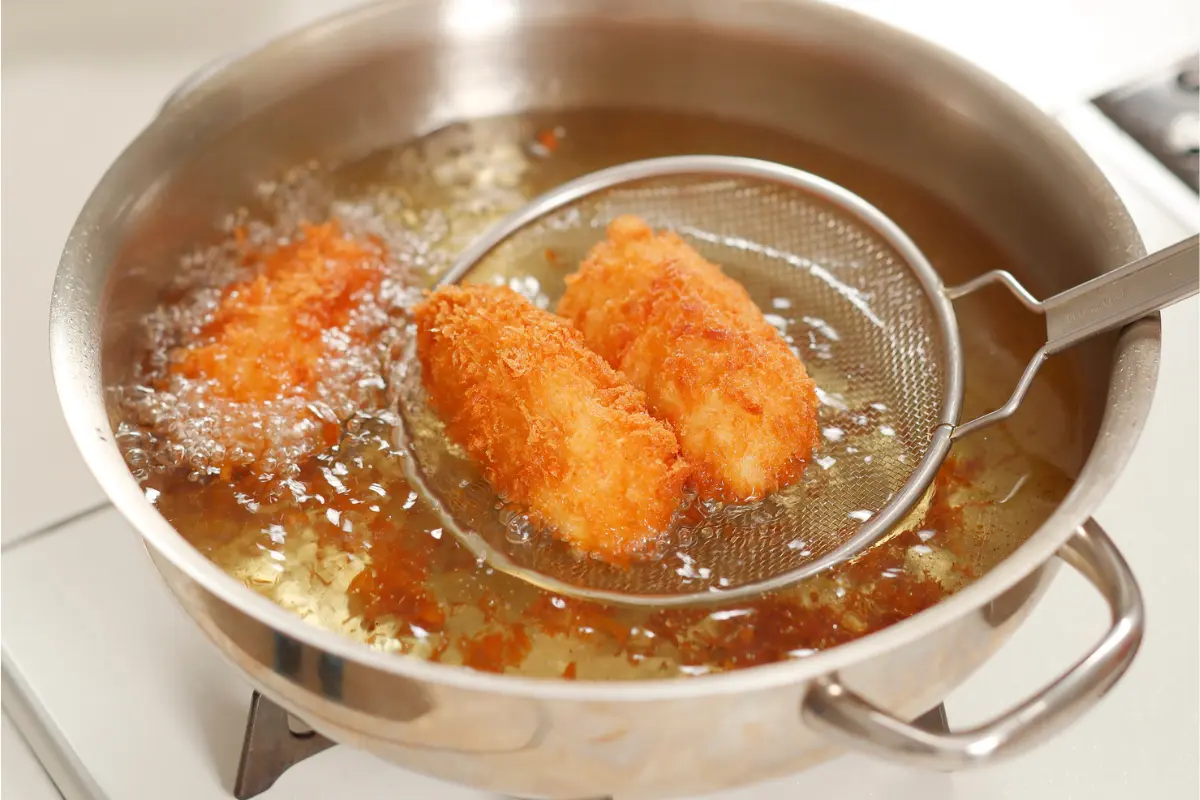 Croquetas dorándose en la sartén, listas para un rebozado crujiente.
